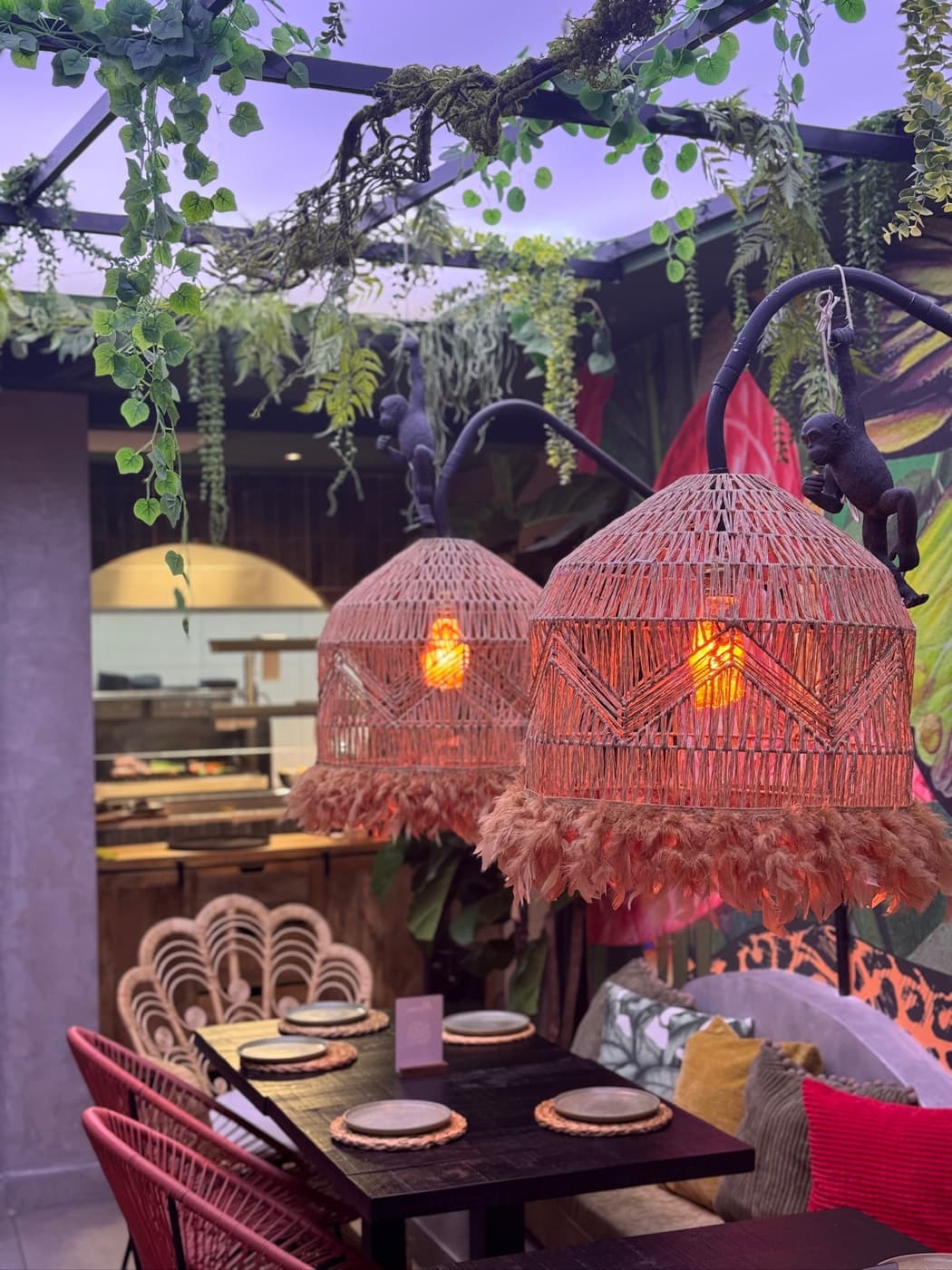 Plant-filled terrace with rattan lamps