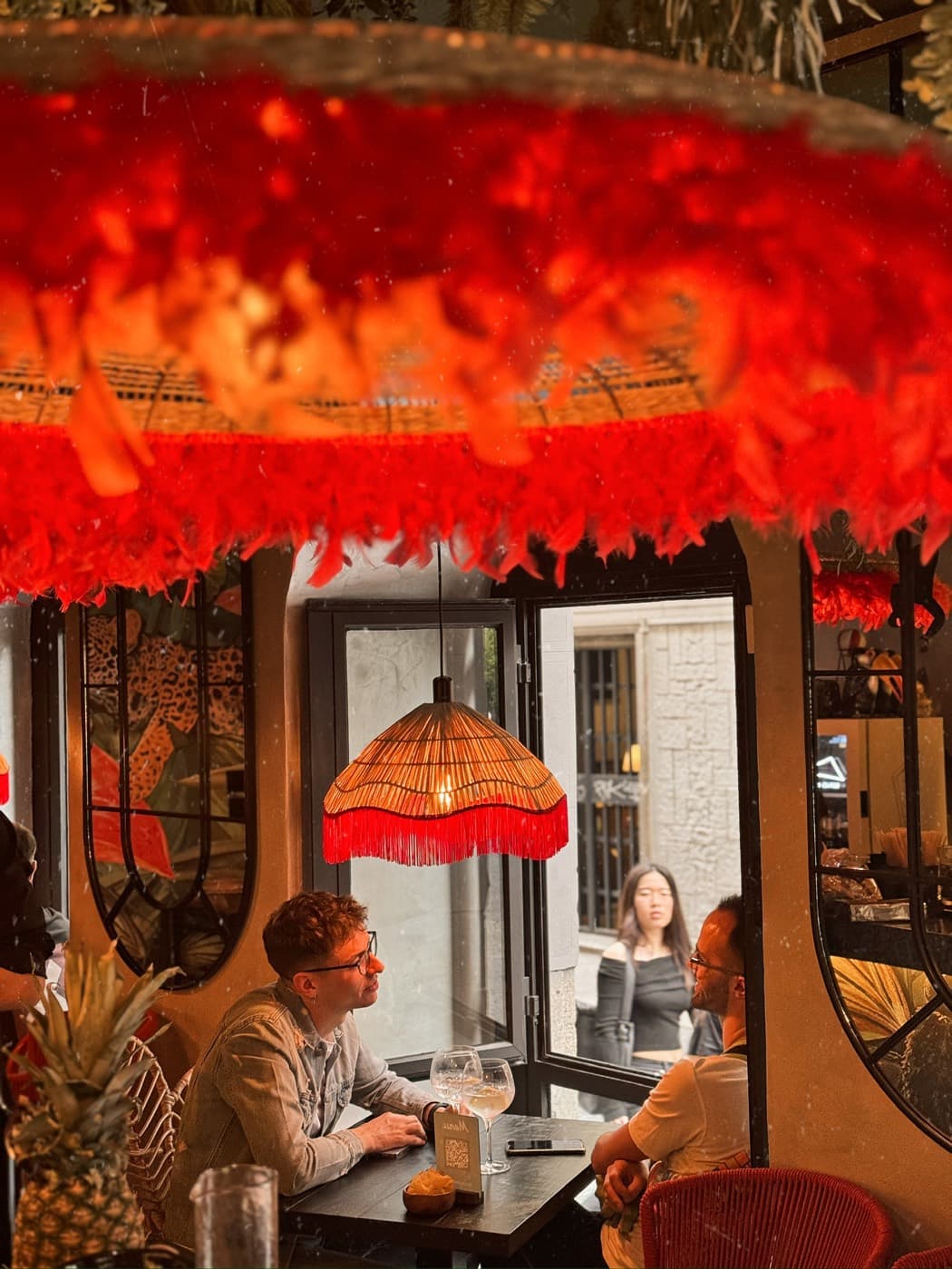 Red feather lamps over the dining room