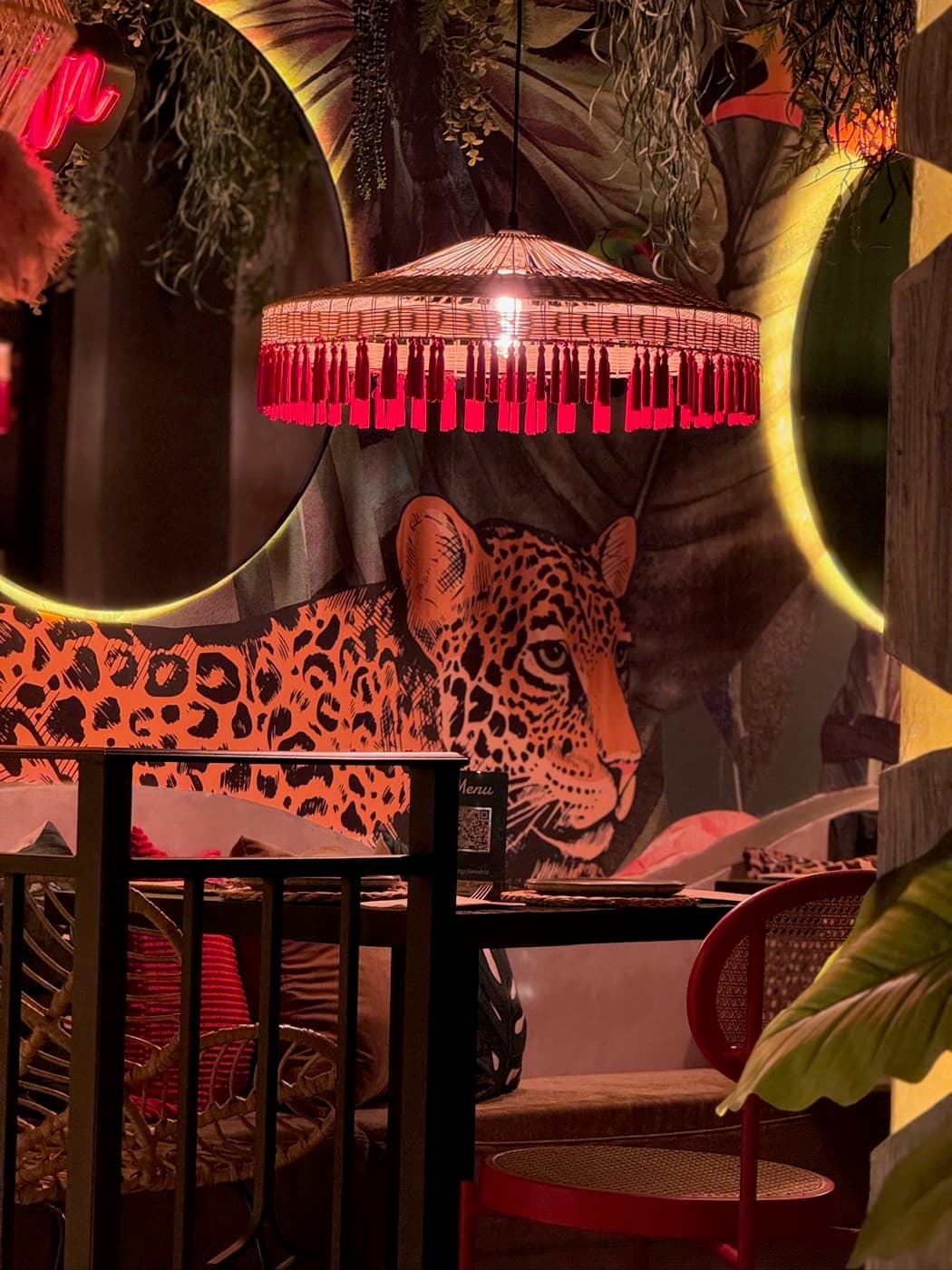 Leopard mural and red fringe lamp
