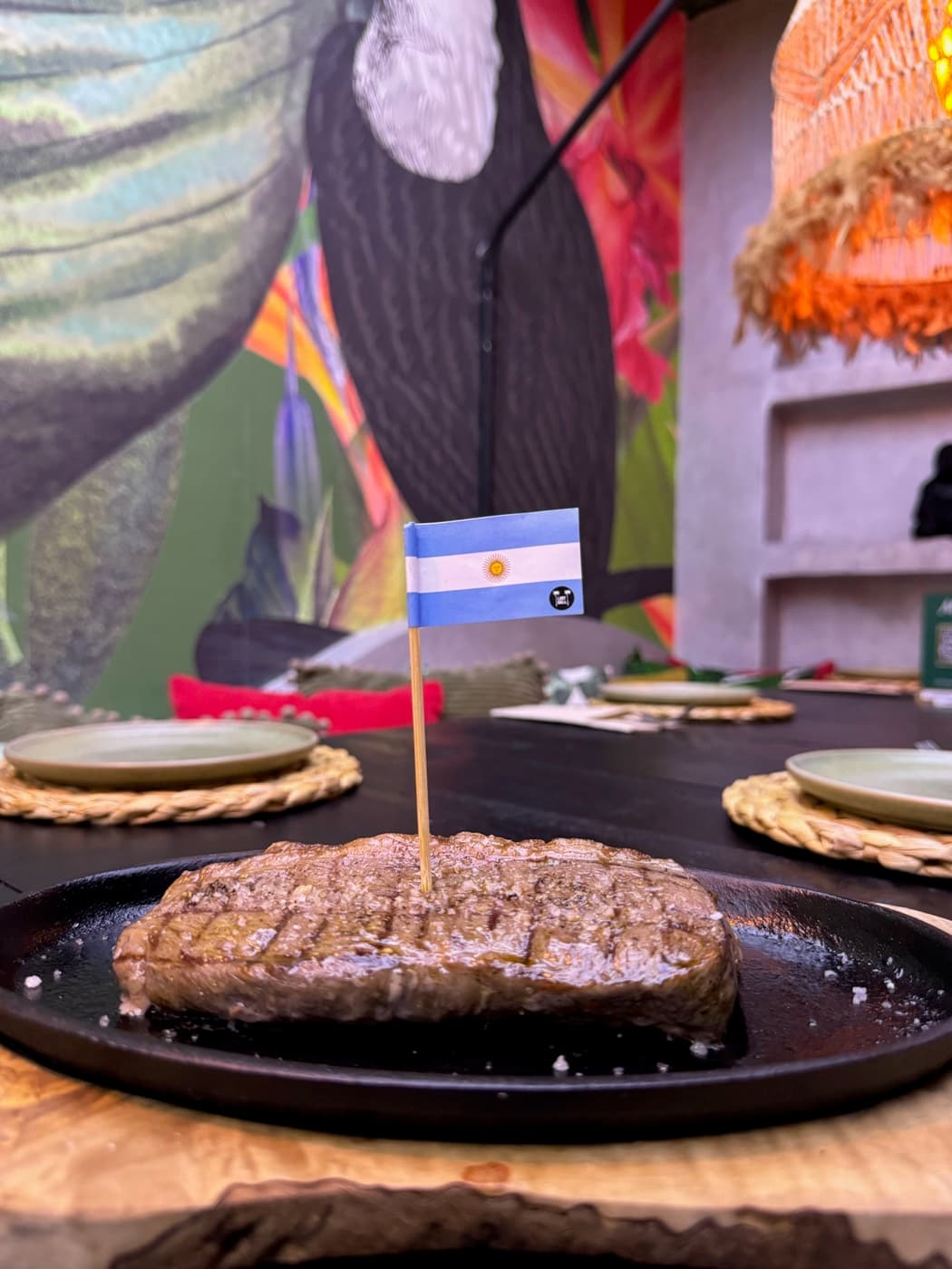 Steak plated in front of the jungle mural